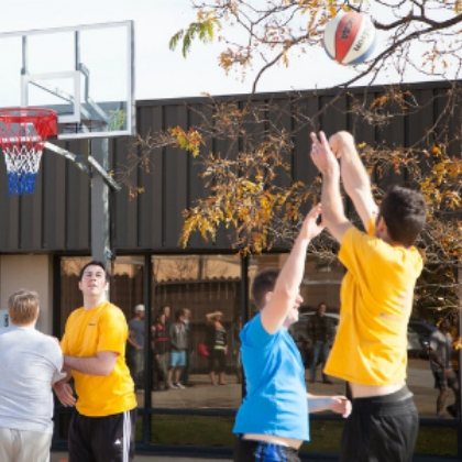 People playing basketball outdoors