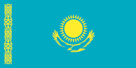 Flag of Kazakhstan with a sky-blue field, a golden sun with 32 rays above a soaring golden steppe eagle, and a national ornamental pattern on the left.
