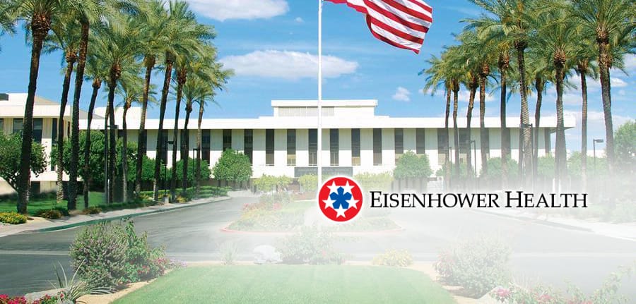 Building with palm trees in the front, an American flag on a pole, and the Eisenhower Health logo.